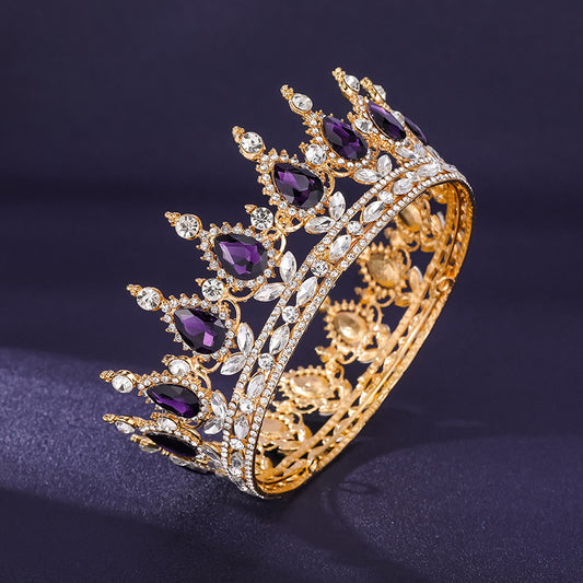 Gold tiara with purple gemstones on a dark purple background