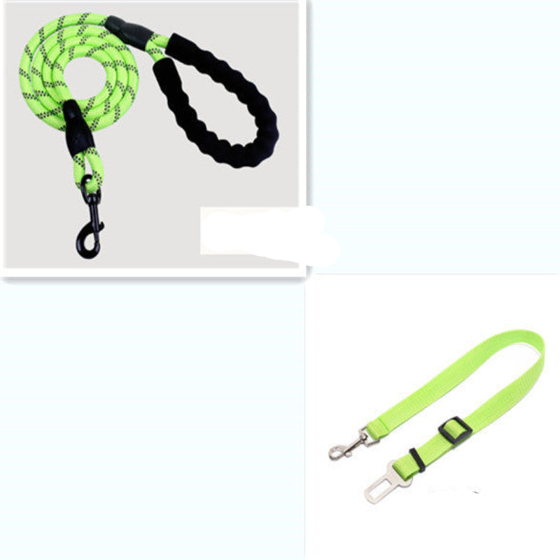 A dog sitting next to its owner on a trail, both wearing the reflective nylon pet dog leash in red color.