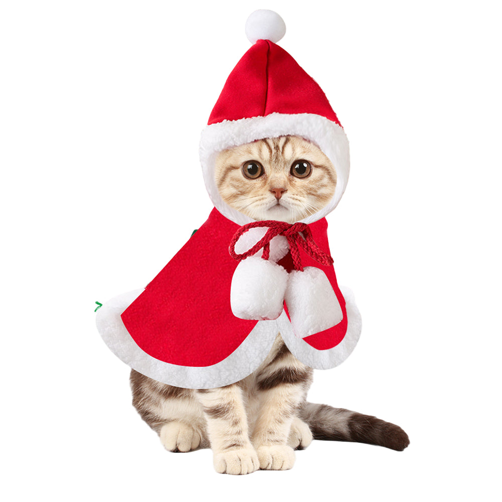 A festive red Santa cape with a white trim and matching hat, designed for pets like cats or small dogs, showcased on a white background with Christmas-themed decorations.