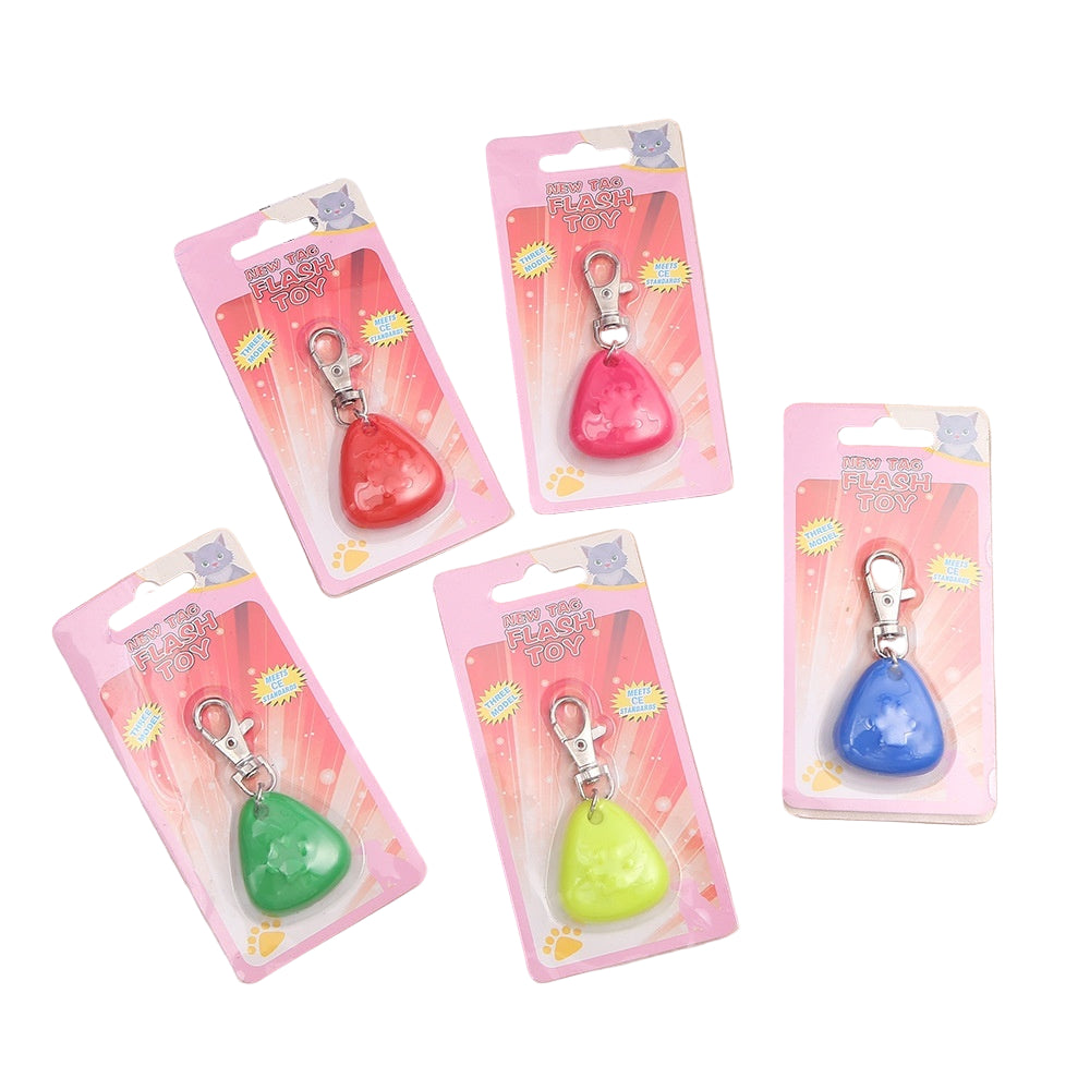 A silicone triangle pendant light in various colors shown with a dog wearing one of the pendants attached to a collar.