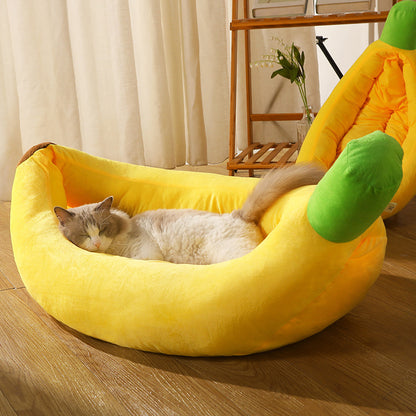 Cat lying on a banana-shaped pet bed in a home setting