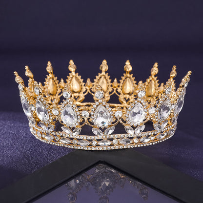 Gold crown with crystals on a reflective surface