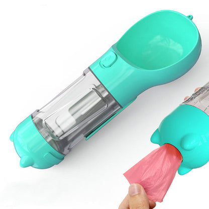A dog using a pink portable water bottle with attached bowl, which is attached to a leash. The bottle appears to be made of plastic and is designed for pet travel use.