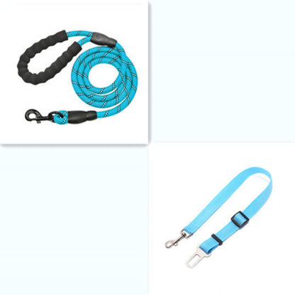 A dog sitting next to its owner on a trail, both wearing the reflective nylon pet dog leash in red color.