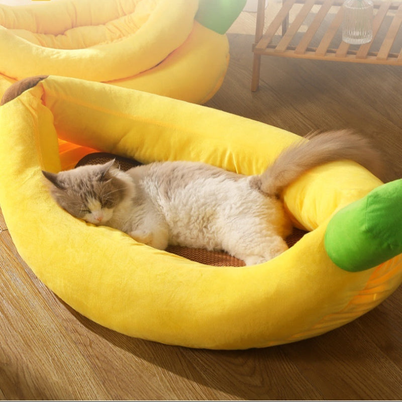 Cat lying in a yellow banana-shaped pet bed with text about comfort and protection.