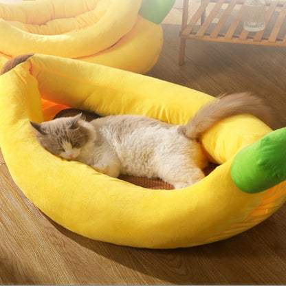 Cat lying in a yellow banana-shaped pet bed with text about comfort and protection.