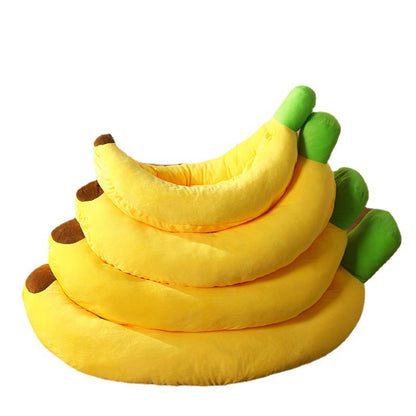 Stack of banana-shaped cushions with green stems on a white background
