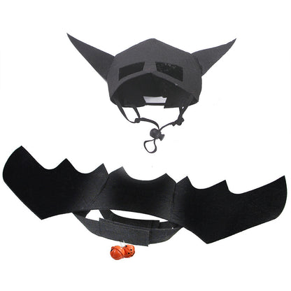 A pet wearing a costume that includes a bat mask with wings.